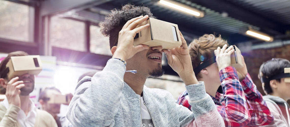 Audience trying virtual reality simulator glasses at technology conference